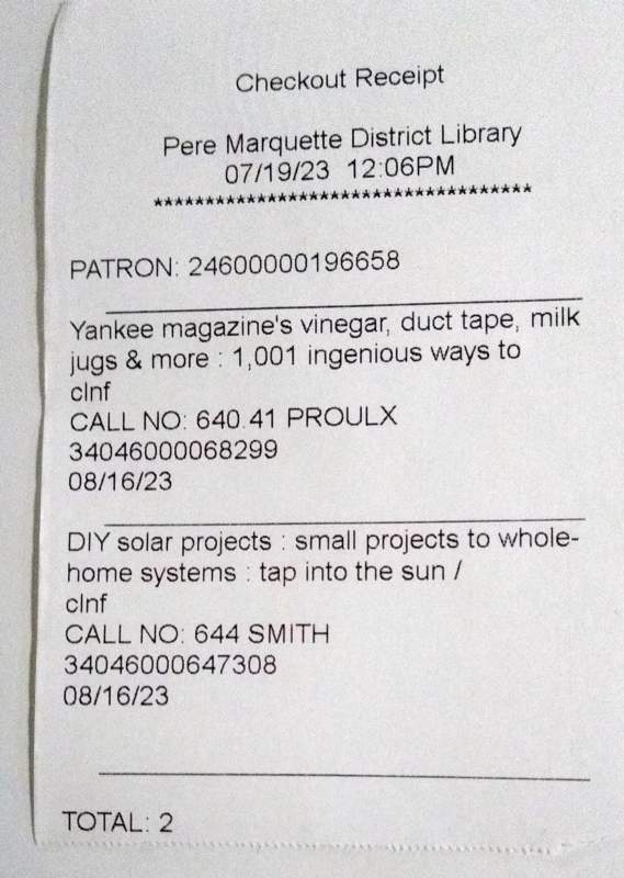 Photo of a checkout receipt from the Pere Marquette District Library showing 2 books being checked out.