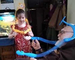 Lyra and Umpa Pete play the monkey game as Draco looks on.