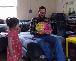 Bill plays with the big slinky as Luna looks on.