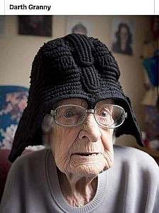 Photo of very wrinkled elderly woman wearing glasses and a black knitted roman type helmet. Caption: Darth Granny.