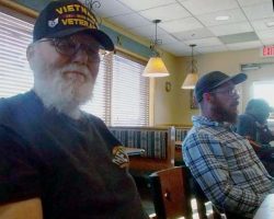 My husband Pete smiling into the camera; Casey's husband Bill sitting in the background.