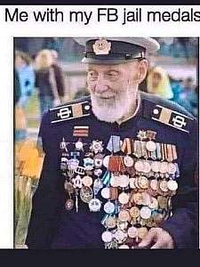 An elderly man with a military dress uniform on; his chest is covered with dozens of medals. Caption: Me with my FB Jail medals.