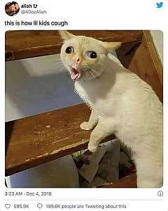 A pathetic white cat with the opposite of crossed eyes, mouth open in a cough. Caption: This is how lil kids cough.