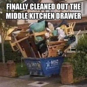 Photo of a overfilled dumpster, overflowing with pallets, furniture, boards, and lots and lots of miscellaneous items. Caption: Finally cleaned out the middle kitchen drawer.
