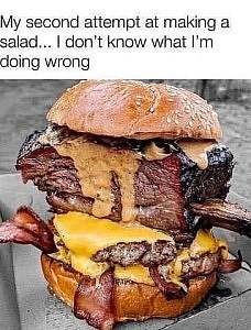 Caption: My second attempt at making a salad...I don't know what I'm doing wrong. Photo of hamburger buns with ribs, burgers, bacon strips, and cheese between them.