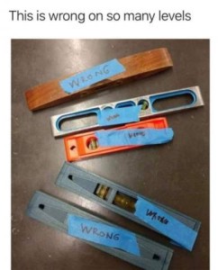 A photo of 5 different carpenters' levels; each has a piece of tape with the word WRONG on it. Caption: This is wrong on so many levels.