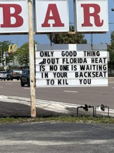 Photo of a sign in front of a bar: Only good thing about Florida heat is no one is waiting in your backseat to kill you.