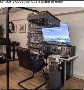 A photo of a huge console with levers and buttons and dials all over it, a radio unit with microphone, and a unit with levers on the floor to the right, another one overhead, and more to the left, in front of a seat with a huge screen on the wall. Caption: Seriously, dude, just buy a plane already!