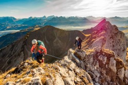 two mountain climbers atop mountains