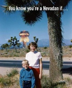 You know you're a Nevadan if... Photo of two children standing unr a tree smiling as their photos are taken; there is a mushroom cloud in the background.