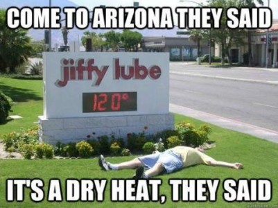 Photo of a man sprawled out on a lawn on his back. There is a jiffy lube sign behind him with a temperature display showing 120°F. Caption: Come to Arizona, they said. It's a dry heat, they said.