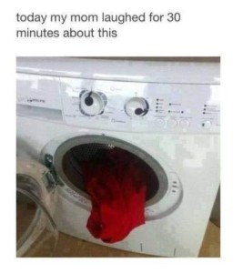 Photo of a front-loading washing machine. The dials above the open door look like googly eyes, one looking up and one looking to the side. Hanging out the door is a red piece of clothing, looking like a stuck-out tongue. Caption: Today my mom laughed for 30 minutes about this.