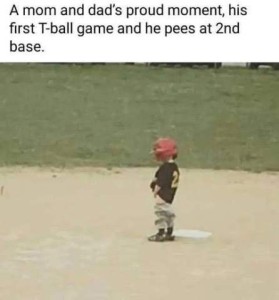 Photo of a wee tot in a baseball uniform out on the ball field. caption: A mom & dad's proud moment, his first T-ball game and he pees at 2nd base.