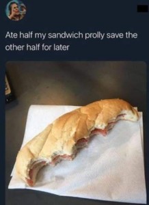 Text: Ate half my sandwich, prolly save the other half for later. Photo of a submarine-type sandwich, half of it eaten lengthwise.