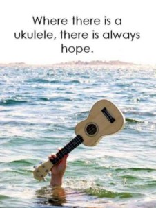 A hand raised above the surface of a lake, holding a ukulele aloft. Caption: Where there is a ukulele, there is always hope.