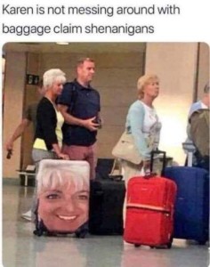 Photo of several people in line at an airport, their luggage at their side. One woman has a closeup photo of her face on the entire side of her suitcase. Caption: Karen is now messing around with baggage claim shenanigans.
