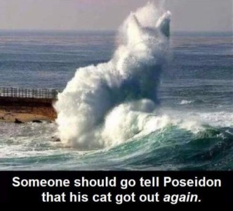 A photoshopped picture of the ocean and waves hitting the breakwater, rising into the air in the form of an enormous cat. Caption: Someone should go tell Poseidon that his cat got out again.