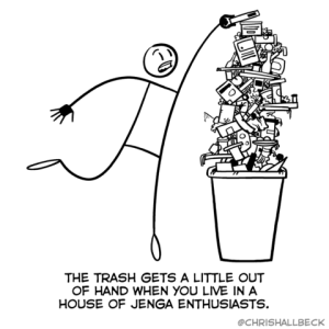 A stick drawing of a person trying to put set something on top of a huge pile of stuff that's way WAY taller than the container that it is in. Caption: The trash gets a little out of hand when you live in a house of Jenga enthusiasts.