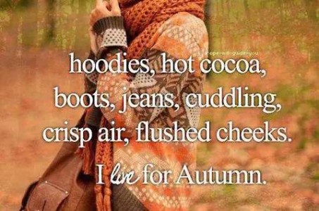 hoodies, hot cocoa, boots, jeans, cuddling, crisp air, flushed cheeks. I live for autumn. (Background is a woman in a sweater with a brown, orange, and tan pattern with a pumpkin-colored scarf, shown only from waist to neck.)