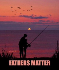Against a sunrise or sunset on a lake which is reflecting the purple, pink, and red hues is the silhouette of a man with a little boy standing in front of him; the man's arms are around boy as he shows the lad how to use the fishing pole that they are holding. Caption: Fathers matter.