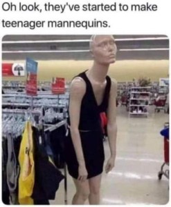 A mannequin in a clothing store wearing a short black tank dress, hunched forward, arms hanging at her sides, face in a pout. Caption: Oh look, they've started to make teenager mannequins!
