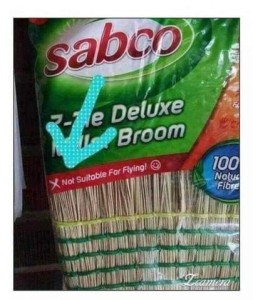 Photo of a straw broom in its wrapper with an arrow drawn on the picture pointing out the words, "Not suitable for flying!"