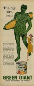 An ad for Niblets canned corn with the Jolly Green Giant holding the hand of a woman about 1/5 his size.