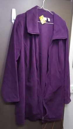 A jacket that looks purple but is actually more of a maroon; It has a large collar and a full zipper.