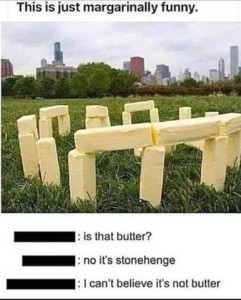 A photo of a stonehenge replica made out of butter sticks. Caption: This is just margarinally funny. Comment 1: Is that butter? Comment 2: No it's stonehenge. Comment 3: I can't believe it's not butter.