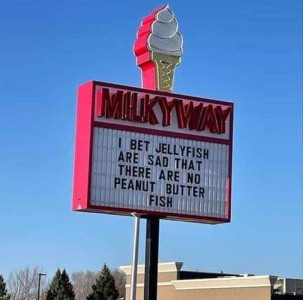A sign in front of an ice cream shop: I bet jellyfish are sad that there are no peanut butter fish.