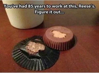 A Reese's peanut butter cup with the wrapper laying on a table and the upside-down candy next to it; part of the chocolate from the bottom is stuck on the wrapper. Caption: You've had 85 yaers to work at this, Reese's. Figure it out...