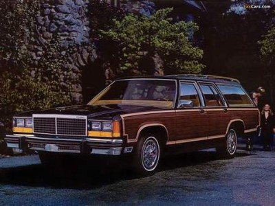 An advertising photo of a shiny station wagon with wood sides.