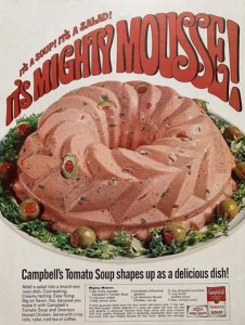 A Campbell's Tomato Soup advertisement showing a pinkish molded food with olives and other bits and pieces in it.