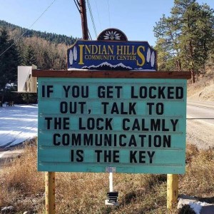 Roadside sign for the Indian Hills Community Center: "If you get locked out, talk to the lock calmly. Communication is the key."
