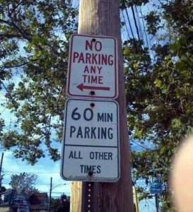 2 parking signs on a pole. Top one says No Parking Any Time. The one below it says 60 Min Parking All Other Times