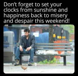 A man sitting on a bench feeding pigeons with the text, "Don't forget to set your clocks from sunshine and happiness back to misery and despair this weekend!