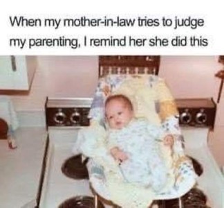 Old photo of a baby in a carrier that is sitting on a stovetop. Caption: When my mother-in-law tries to judge my parenting, I remind her she did this.