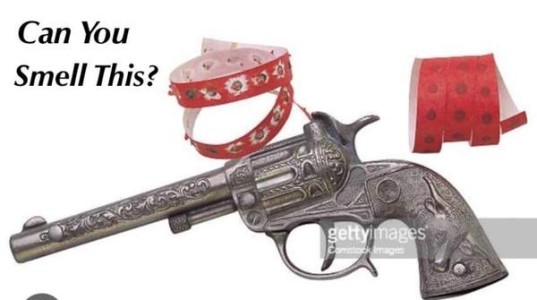 Photo of a cap gun and caps. Caption: Can you smell this?