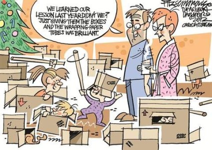 Cartoon showing 3 children and a cat in a living room packed with boxes and cardboard tubes. A Christmas tree stands in the upper left corner. Amid the chaos stands their parents in their pajamas and robes; the mom is holding a cup of coffee. The dad is telling his wife, "We learned our lessong last year didn't we? Just giving them the boxes and the wrapping paper tubes was brilliant!"