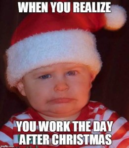 Shoulders-up photo of a toddler wearing a santa hat, his face scrunched up, with the caption: when you realize you work the day after Christmas