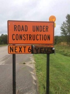 An orange construction sign that has had the last word covered to say YEARS. So the sign says Road under construction next 6 years.