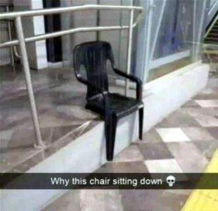 Picture of a black plastic patio chair without back legs that is set with the back on a porch, with the front legs hanging down. Caption: Why this chair sitting down