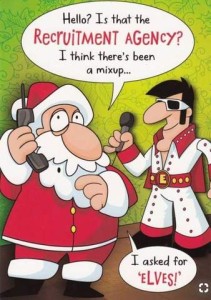 Cartoon of Santa on the phone. Next to him is Elvis Presley holding a microphone. Santa is talking on the phone, saying, "Hello? Is that the recruitment agency? I think there's been a mixup...I asked for ELVES!"