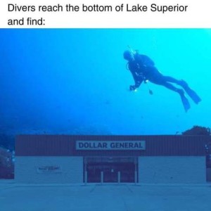 Divers reach the bottom of Lake Superior and find: Photo of a diver underwater looking down at a Dollar General store