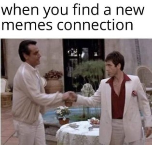 Photo of two men in casual wear in a fancy restaurant, shaking hands while eyeing each other suspiciously. Caption: When you find a new memes connection