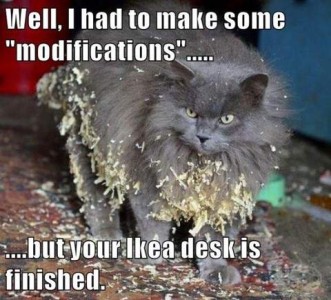 Photo of a long-haired gray cat with tons of sawdust and wood shavings in the fur on his legs, chest, and belly. Caption: Well, I had to make some "modifications"...but your Ikea desk is finished.