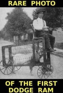 Photo of a man sitting in a seat atop a bottomless wire cage with a wooden frame and wheels at the corners. Inside is a sheep, all 4 feet on the ground. Caption: Rare photo of the first Dodge Ram