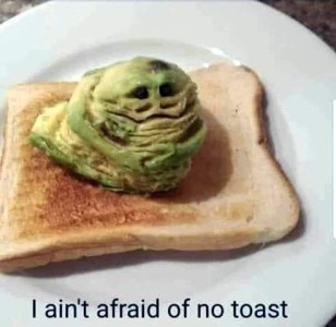 A piece of toast with a blob of avacado on top formed into a Jabba the Hutt character. Caption: I ain't afraid of no toast.