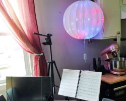 Our lighted ball got moved from the front window, where it had been interfering with the shade, to its own spot in the "music corner"; the vines that had been around the kitchen window will keep the PoiBoiz from using the bracket above as a perch (in an ideal world).