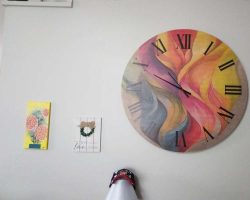 Finally, the clock wall is now sharing space with the lovely flowers Gwen painted for me and the other sign from Lyra to the left...